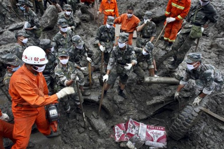 Rescuers search for victims after a landslide in Gongshan county, in southwest China's Yunnan province, Friday, Aug. 20, 2010. Rescue crews searched Friday for scores of people left missing and feared dead in southwestern China after torrential rains triggered massive mudslides during a summer plagued by deadly rains and flooding. (AP Photo) ** CHINA OUT **